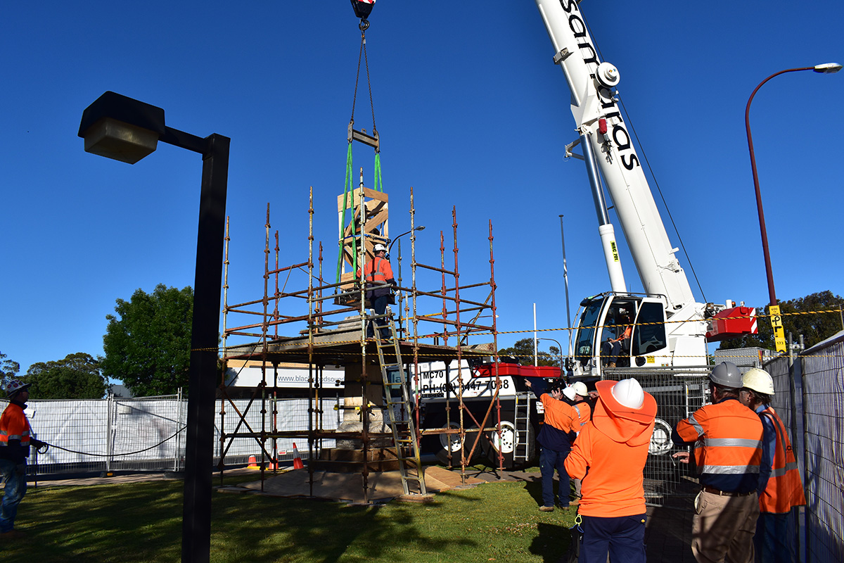 Crane lifting monument