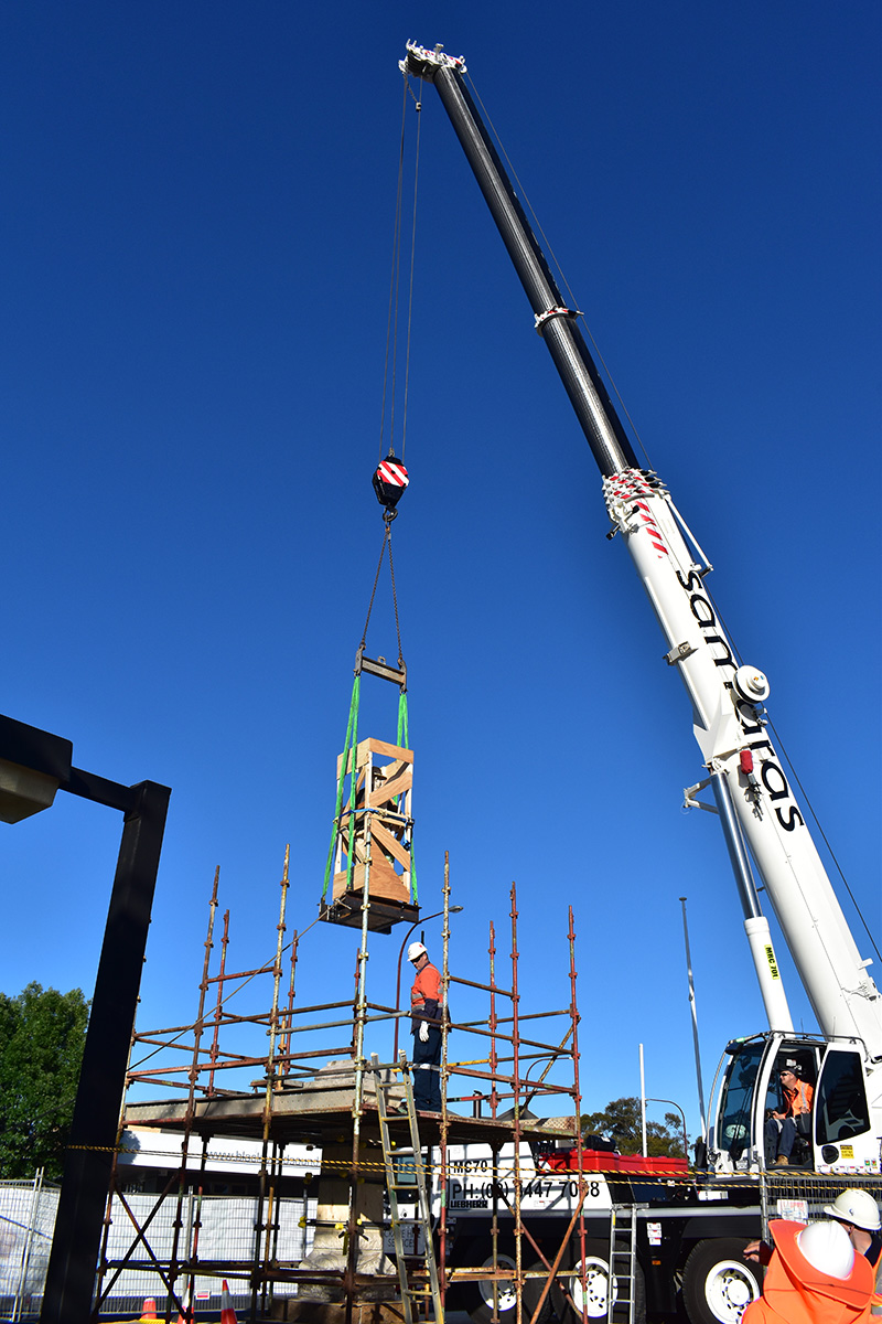 Crane lifting monument