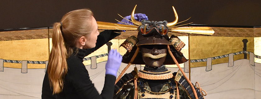 Conservators installing Samurai armour