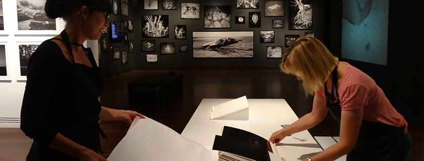 Jodie Scott and Liz Mayfield installing Trent Parke: The Black Rose, Art Gallery of South Australia, Adelaide, 
