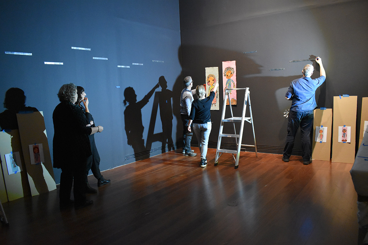People installing artworks at Art Gallery of SA
