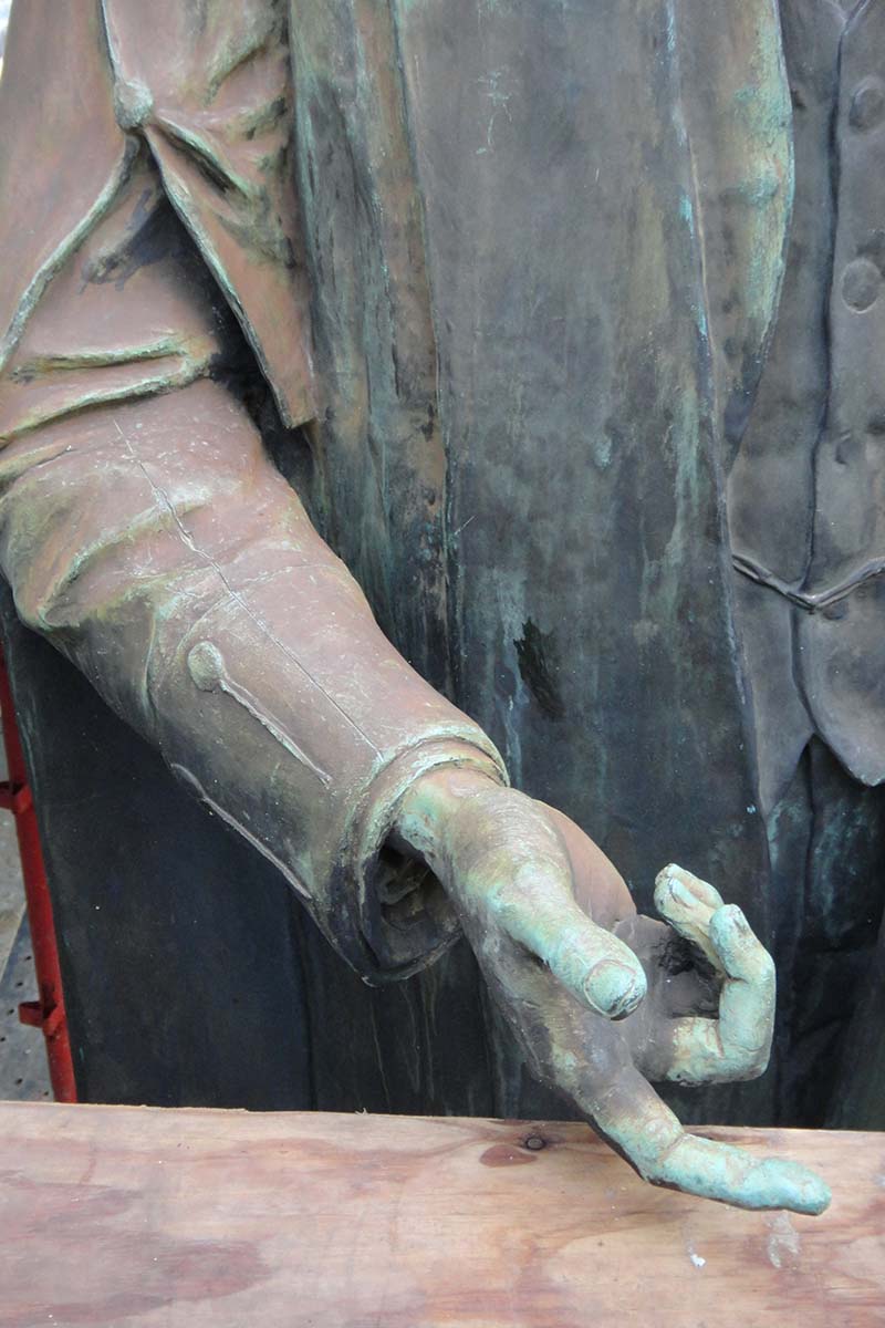 Detail of hand of memorial before conservation treatment